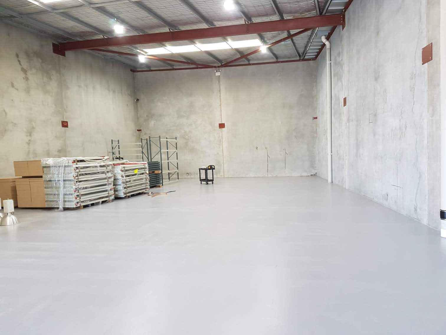 A freshly prepared warehouse floor at Searle Fasteners in Canning Vale, ready for a full shelving fitout by Backsafe Australia.