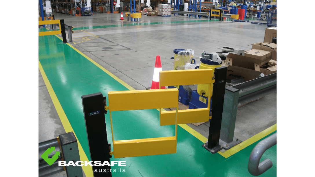 Industrial pedestrian safety gate by Backsafe AU installed along warehouse walkway with clear traffic demarcation and cone-marked access route.