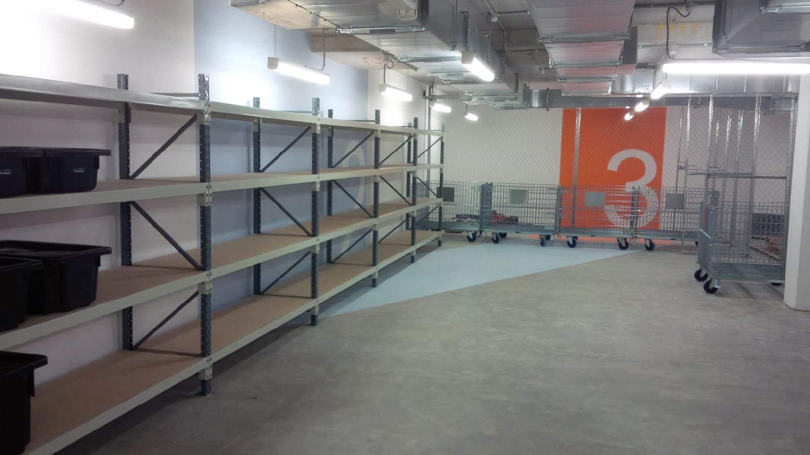 Backsafe shelving installation and mesh stillage trolleys at the Elizabeth Quay project, featuring long-span storage racks and bin containers in a secured, industrial-fit facility.