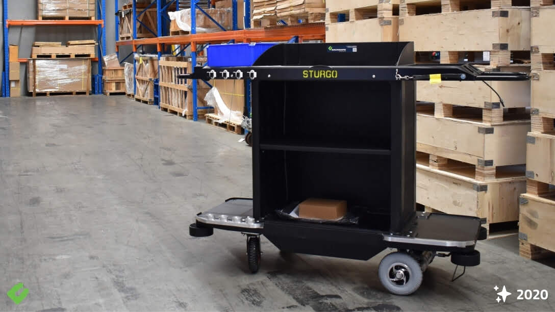 Backsafe STURGO housekeeping trolley designed for WA mine camps, featuring heavy-duty wheels, modular shelving, and tool hooks in a warehouse environment.